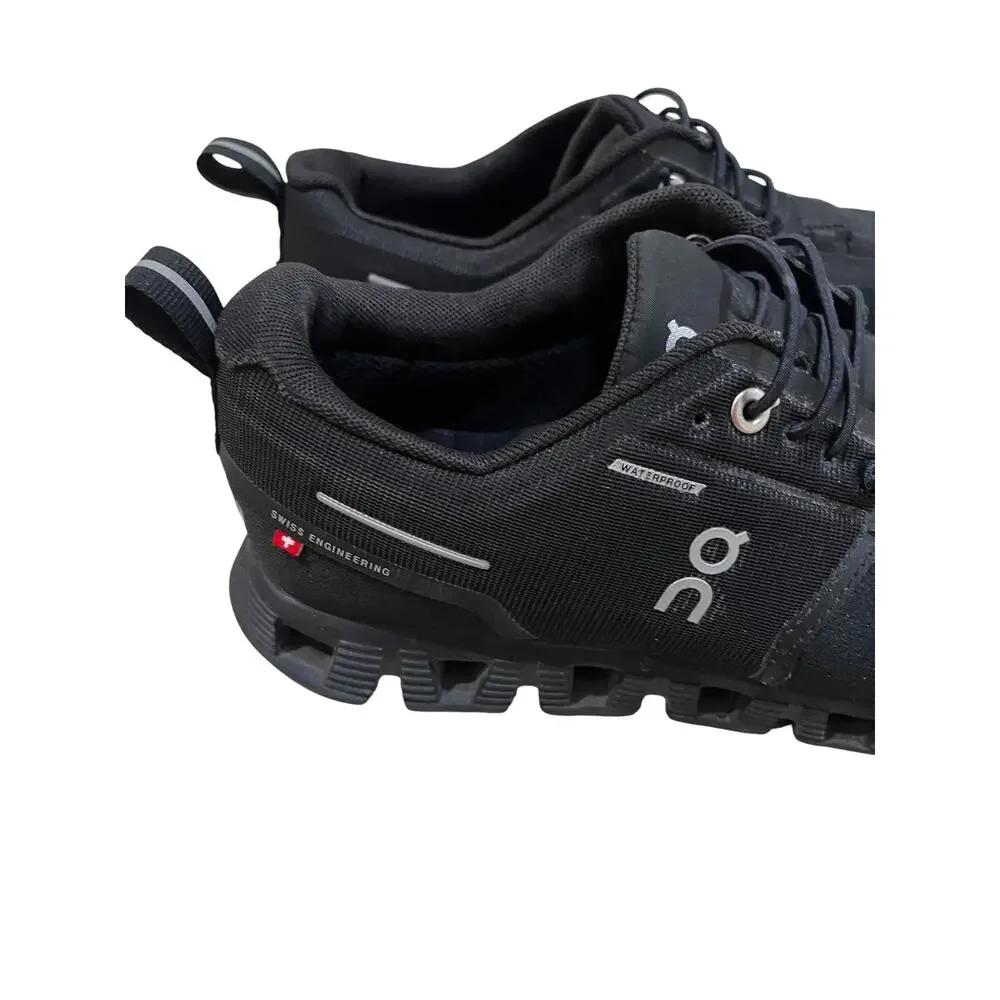 On Cloud waterproof running shoes for women in solid black.